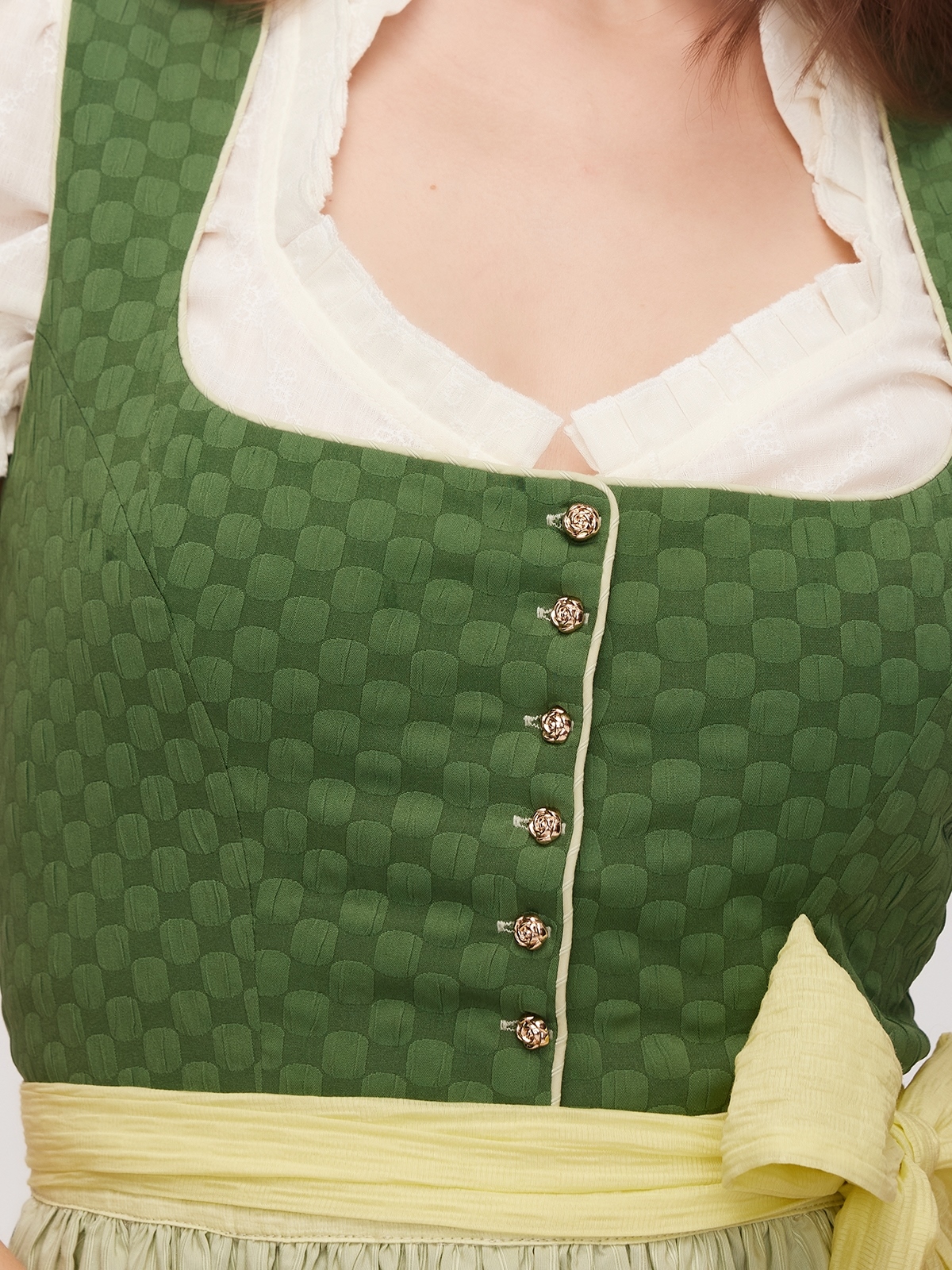 Modernes Dirndl in Grün mit figurbetonter Schnürung